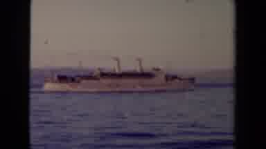 France (1945): Steam Ship Sailing On A Calm Ocean With Shoreline In Background