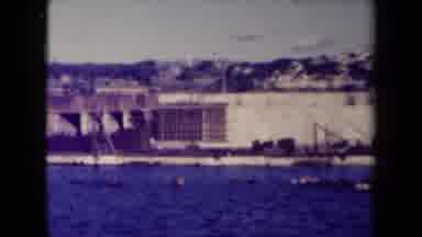 France (1945): Town Buildings Sea Construction Old Videotape Style Showing Bridge