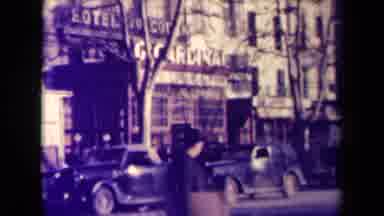 France (1945): People Walking An A City Across Streets With Buildings And
