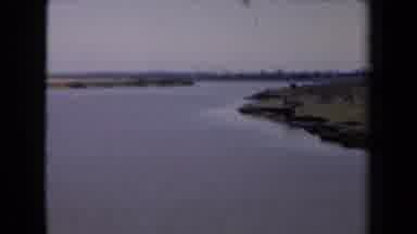 Netherlands (1946): View Of Calm Sea Against Green Coast Line On A Cloudy Day