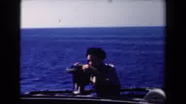 Netherlands (1946): Man On Boat On Dark Blue Water Looking Through Device