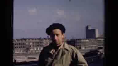 Netherlands (1946): A Man In A Black Hat Interviewing In An Abandoned Area