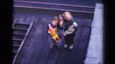 Netherlands (1946): Two Little Girls Holding Dolls And Waving To The Camera