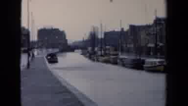 Netherlands (1946): Some Vehicles Are Moving Through The Wet Road And Lot Of