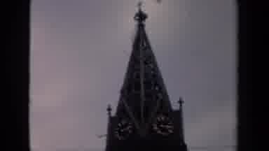 Netherlands (1946): The Tip Of A Church With The Clock And A Car Driven By Two