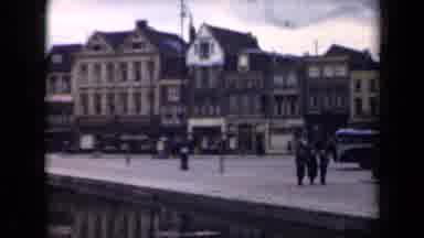 Netherlands (1946): People Walking Near A River In The Middle Of A City