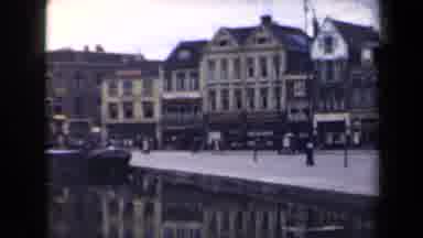 Netherlands (1946): Bustling Shipyard With Busy Shoppers In A Quaint Town Setting