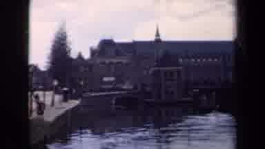Netherlands (1946): A Building With A Waterway In The Front And People Walking In