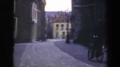 Netherlands (1946): Two Kids Crossing The Street After A Man In A Bike Passes By