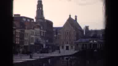 Netherlands (1946): There Are Multiple Buildings With Someone Riding A Scooter In