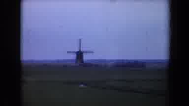 Netherlands (1946): Old Non Working Windmill On A Large Field With Old Car Sitting