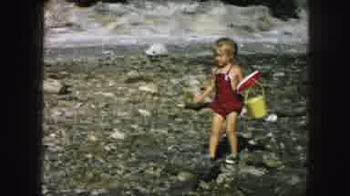 Kansas City Missouri (1959): A Little Girl In A Red Jumper Waddles Across A Rocky