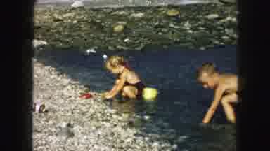 Kansas City Missouri (1959): Young Child Playing With Rocks And A Bucket In A
