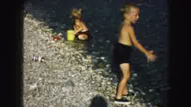 Kansas City Missouri (1959): Two Young Children Playing In The Water On A Rocky
