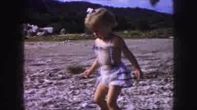 Kansas City Missouri (1959): Child Wearing Dress Walking Across A Rock Covered