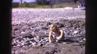 Kansas City Missouri (1959): Infant Girl Exploring A Rocky Beach On A Sunny Day
