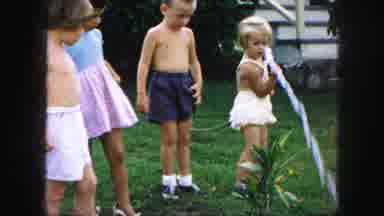 Kansas City Missouri (1959): Children In The Backyard Playing With Water Watering