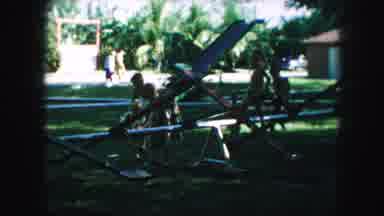 Kansas City Missouri (1959): Small Kids Playing On A Teeter Totter At A Park With