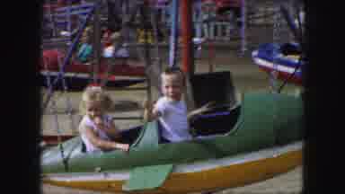 Kansas City Missouri (1959): Two Young Blonde Children On A Swinging Plane Ride At