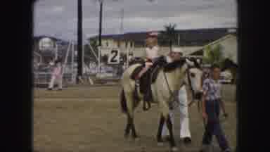 Kansas City Missouri (1959): Young Girl Wearing A Party Hat Is Horseback Riding In