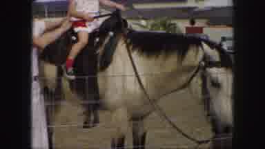 Kansas City Missouri (1959): Man Holding Blonde Headed Girl On A Horse And People