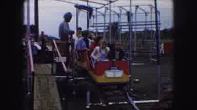Kansas City Missouri (1959): A Group Of People Riding A Small Four Car