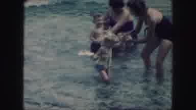 Kansas City Missouri-1959: Two Mothers Play In The Ocean With Their Children