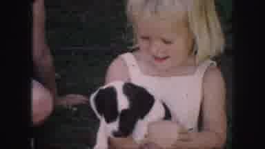 Kansas City Missouri (1959): Little Girl Holds Puppy Before Little Boy Plays With