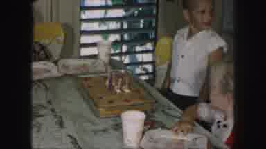 Kansas City Missouri (1959): A Kid Is Blowing Out The Candles Put On The Cake And