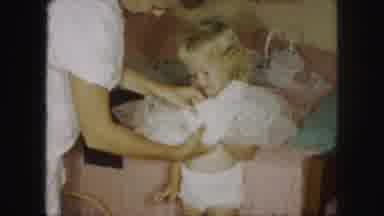 Kansas City Missouri (1959): A Mom Putting A Dress On Her Daughter