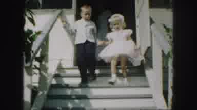 Kansas City Missouri (1959): A Young Boy And Girl In A Suit And Dress Walking Down