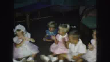 Kansas City Missouri (1959): Mother Attending To Many Clapping Children Seated On