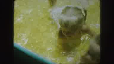 Kansas City Missouri (1959): Young Boy And Girl Crawl And Splash In Yellow