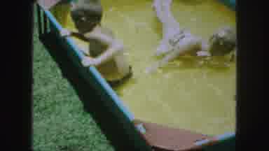Kansas City Missouri (1959): Two Kids Are Playing In The Water Kept In A Small Tub