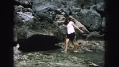 Kansas City Missouri (1959): Walking Barefoot On A Rocky Beach At The Bottom Of A