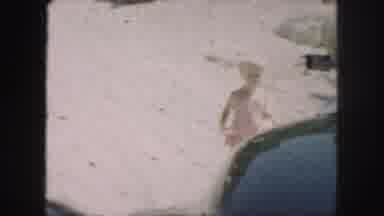 Kansas City Missouri (1959): Child Running Across Sand And Three People At A Pool