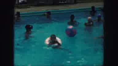 Kansas City Missouri (1959): Young Boy In A Inner-Tube Floats In A Pool Surrounded