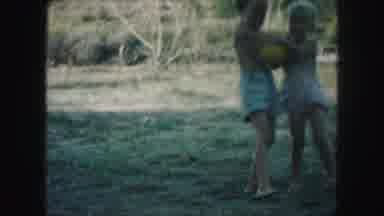 Kansas City Missouri (1959): Kids Playing A Girl Playfully Chasing A Boy Trying To