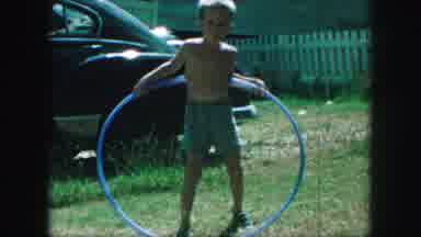 Kansas City Missouri (1959): Young Boy Hula Hooping In Backyard During Summer In