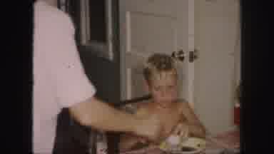 Kansas City Missouri (1959): A Boy Is Eating Something With Half Naked Body And