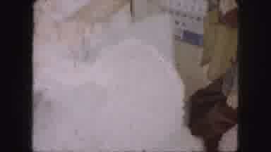 Kansas City Missouri (1959): A Girl Is Making Up Her White Colored Dress Inside