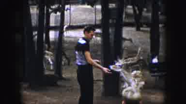 Kansas City Missouri (1959): Young White Male Adult Feeds Deer At Zoo On A Cloudy