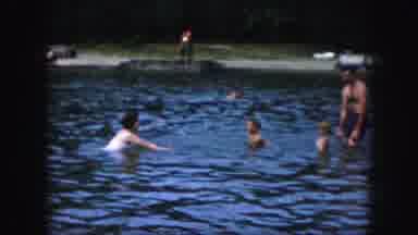 Kansas City Missouri (1959): Child Splashing Water On An Adult With Other People