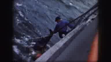 Kansas City Missouri (1959): A Man On A Boat Rescues A Man In The Water While