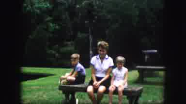 Kansas City Missouri (1959): A Mom With Two Children Sitting On A Bench Dressed