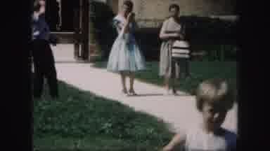 Kansas City Missouri (1959): Two Women In Dresses Walk Down The Walk Way Together