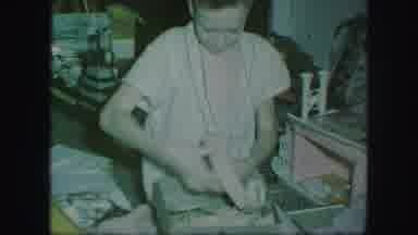 Kansas City Missouri (1959): A Young Boy Opening Presents Christmas Morning In His