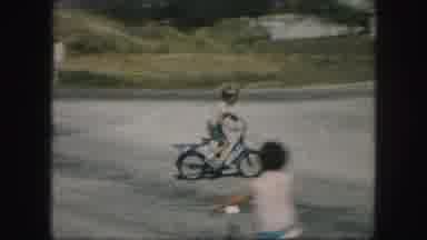Kansas City Missouri (1959): Young Kids Riding Their Bikes On The Street In A Calm