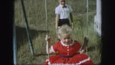 Kansas City Missouri (1959): Little Boy And Girl Play Together On The Swing Set