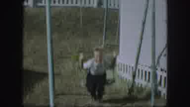 Kansas City Missouri (1959): A Boy And Girl Use A Swing Sited On The Lawn Of A